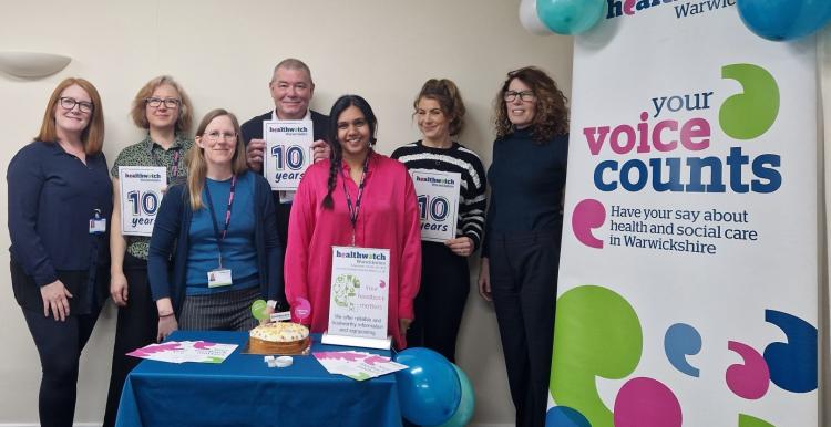 Healthwatch Warwickshire staff and 10 year anniversary display