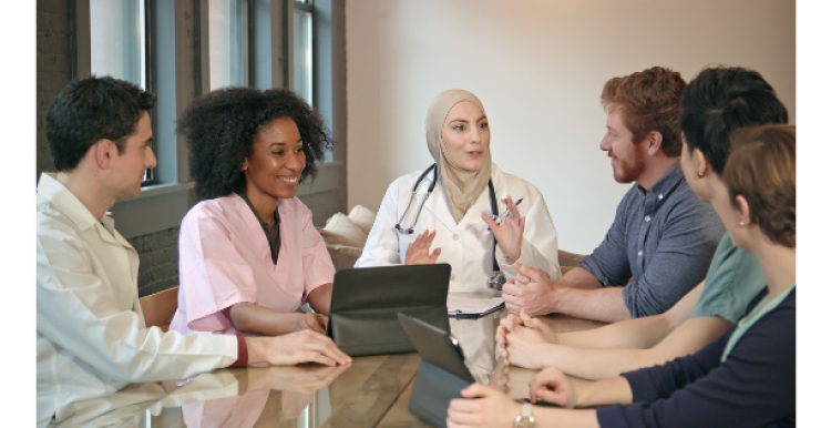 Group of medical staff and academics meeting around a table