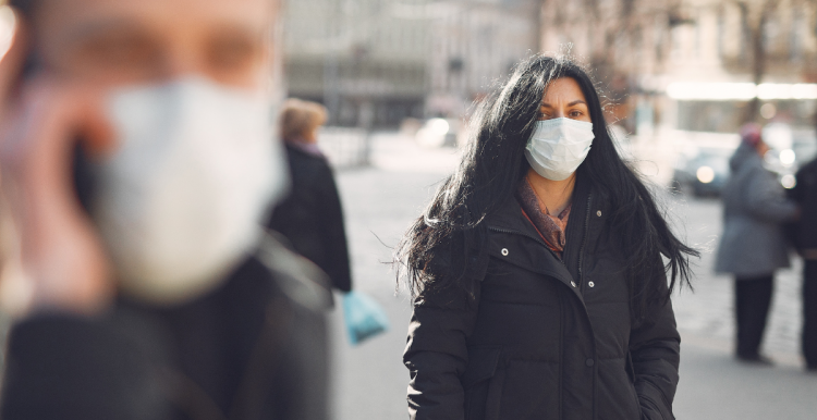 people in the street wearing masks